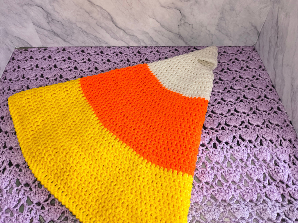 Flat lay of candy corn costume pieces showing yellow, orange, and white color sections