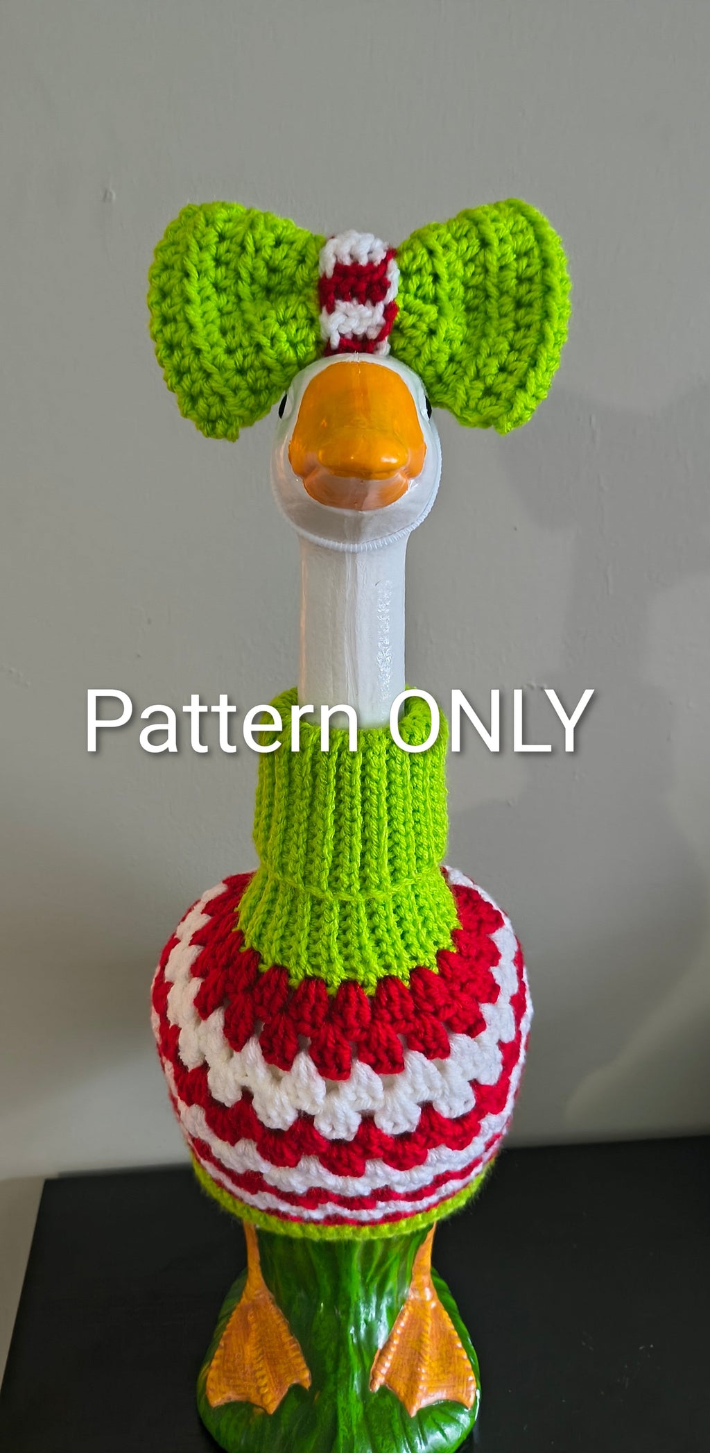 Green, red and white crochet porch goose granny sweater with green bow - front view