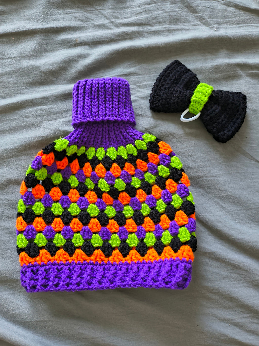 Green, red and white crochet porch goose granny sweater with green bow on head - back view