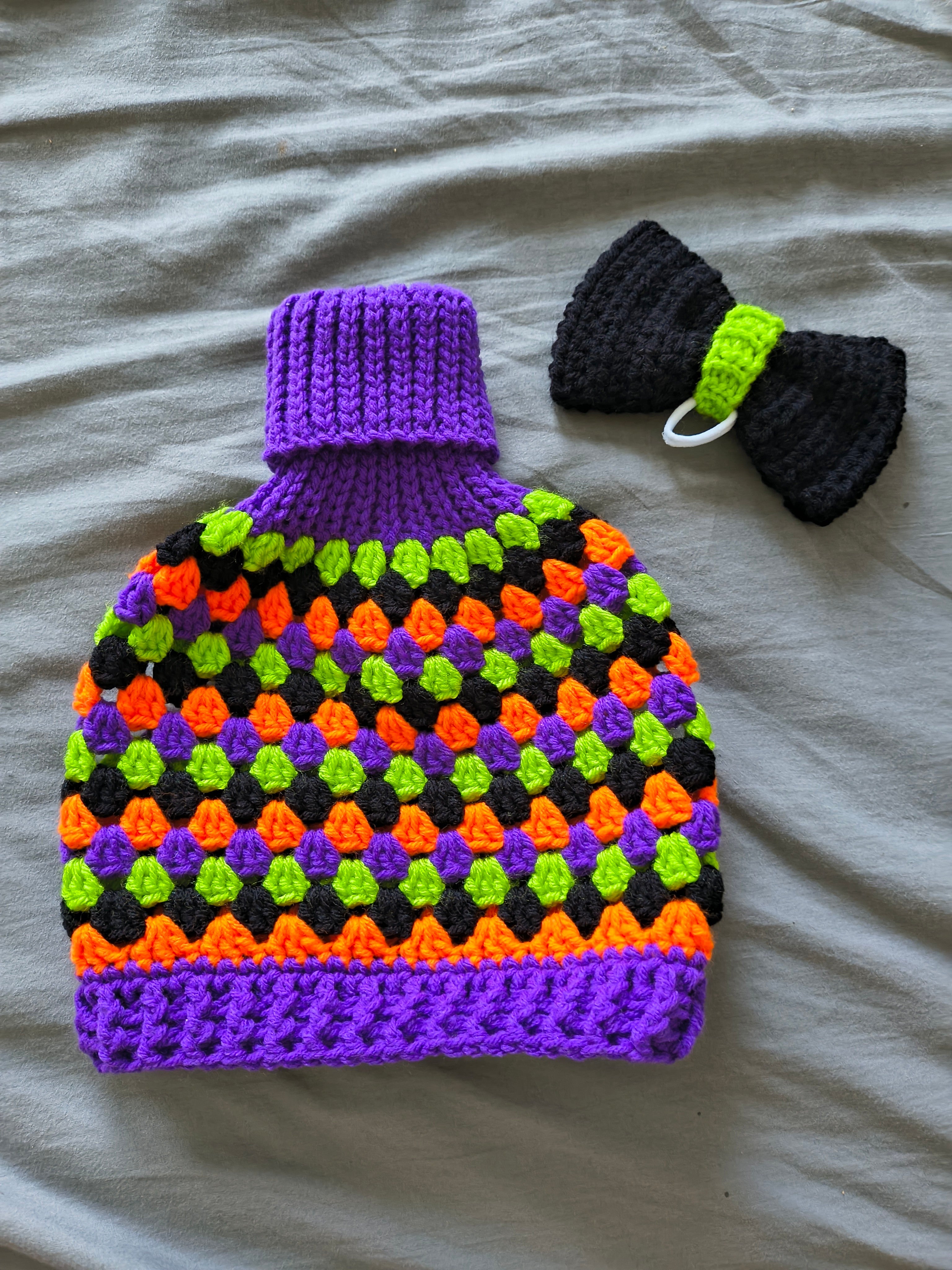 Green, red and white crochet porch goose granny sweater with green bow on head - back view