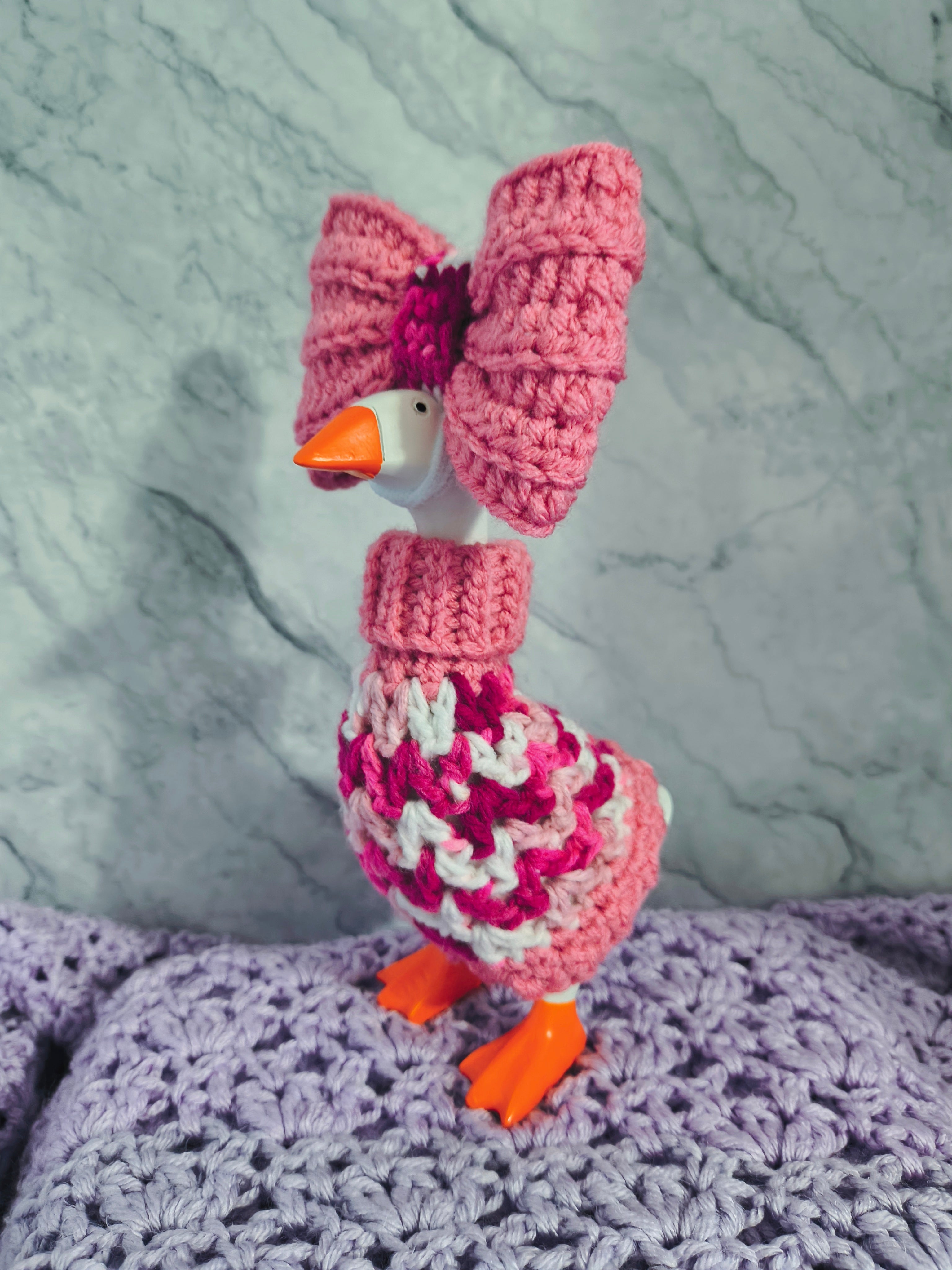 Pink crochet desk goose turtleneck sweater with large pink bow - front view